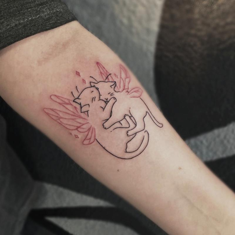 Милые котята с крыльями на предплечье отлично подойдут для первой тату девушке